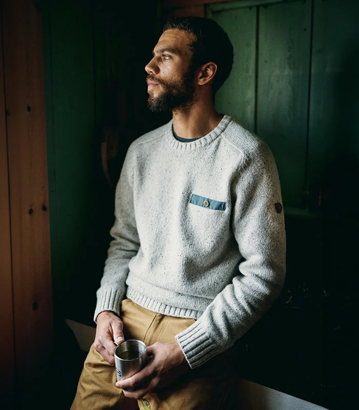 Man with a light grey sweater.