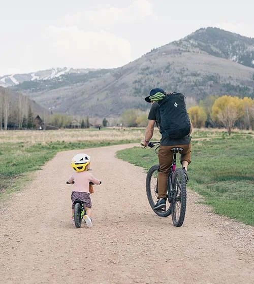 Man on bike and child on bike.