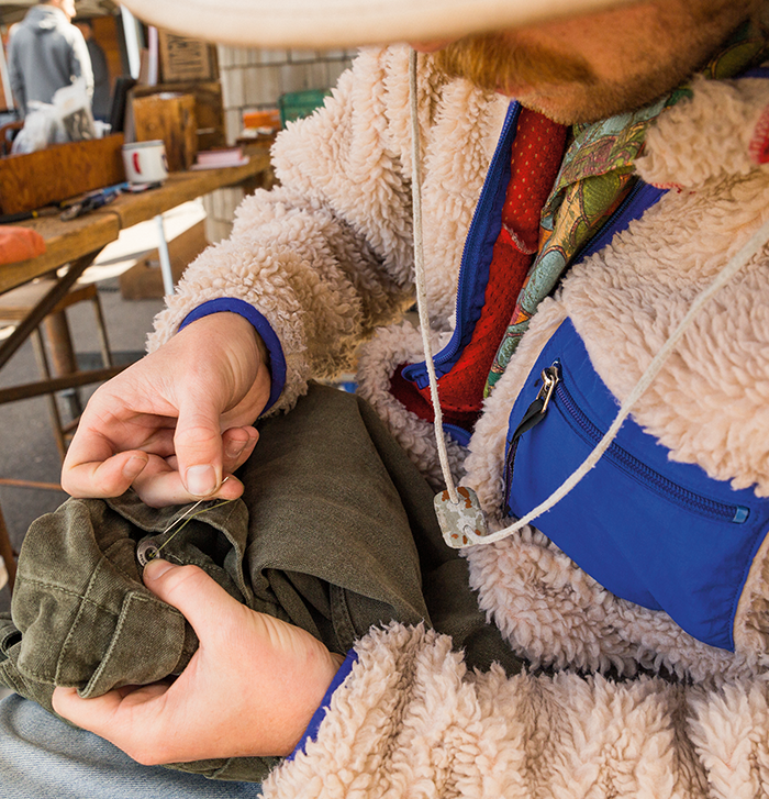 Man working on a pair of pants
