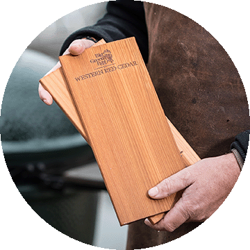 Person holding cedar planks.