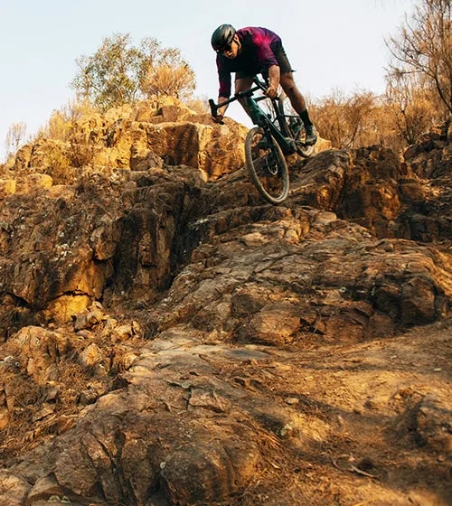 Mountain biker descending down rocks.
