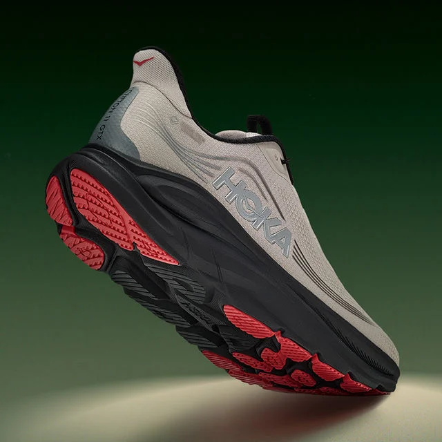 Hoka running shoe with red outsole detail