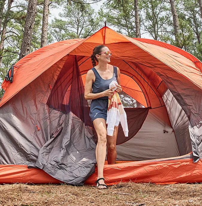 Woman exiting a tent.