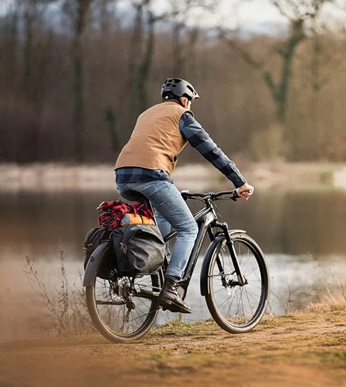 Man biking near lake.