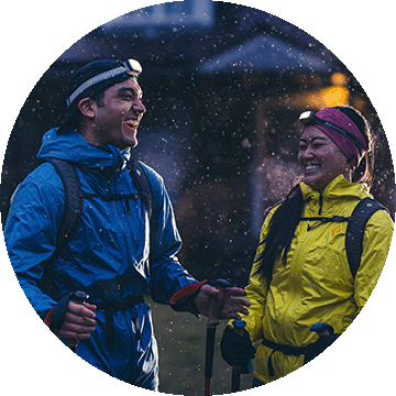 Two people laughing at night.