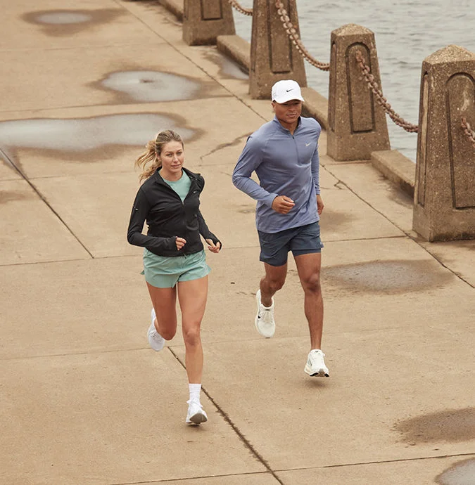 Two runners running on pavement.