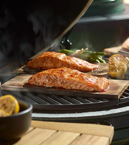 Two pieces of Salmon cooked on cedar boards.