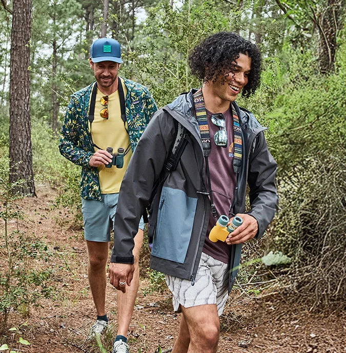 Two people walking down a trail.
