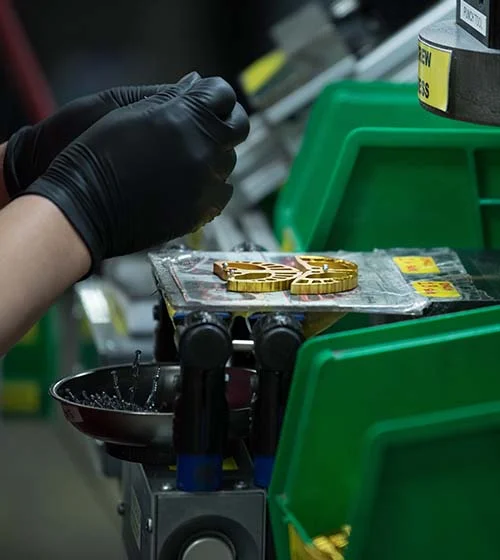 Factory worker assembling gear.