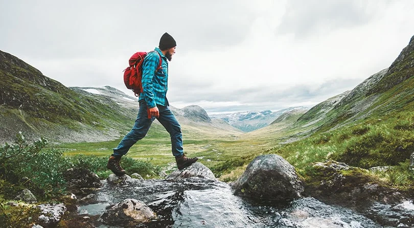 A man crossing a stream.