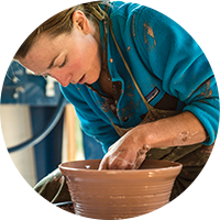 Woman throwing pottery.