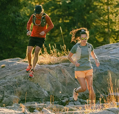 Two people running down a trail.