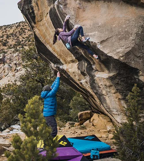 Climber spotting another climber.