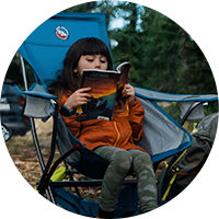 Child reading on a chair.