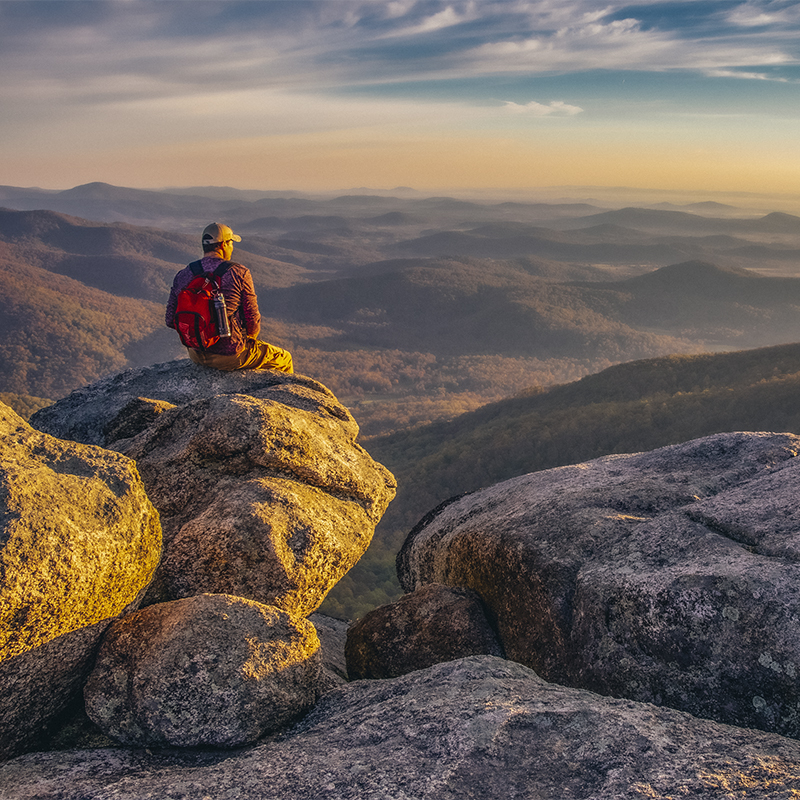A hiker enjoying the view on Old Rag Mountain in Shenandoah Wilderness at Sunrise