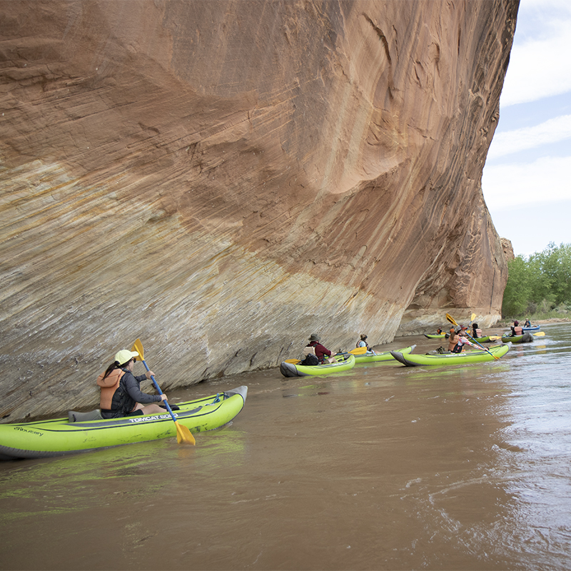 Representatives of Public Lands kayak on the San Juan River 