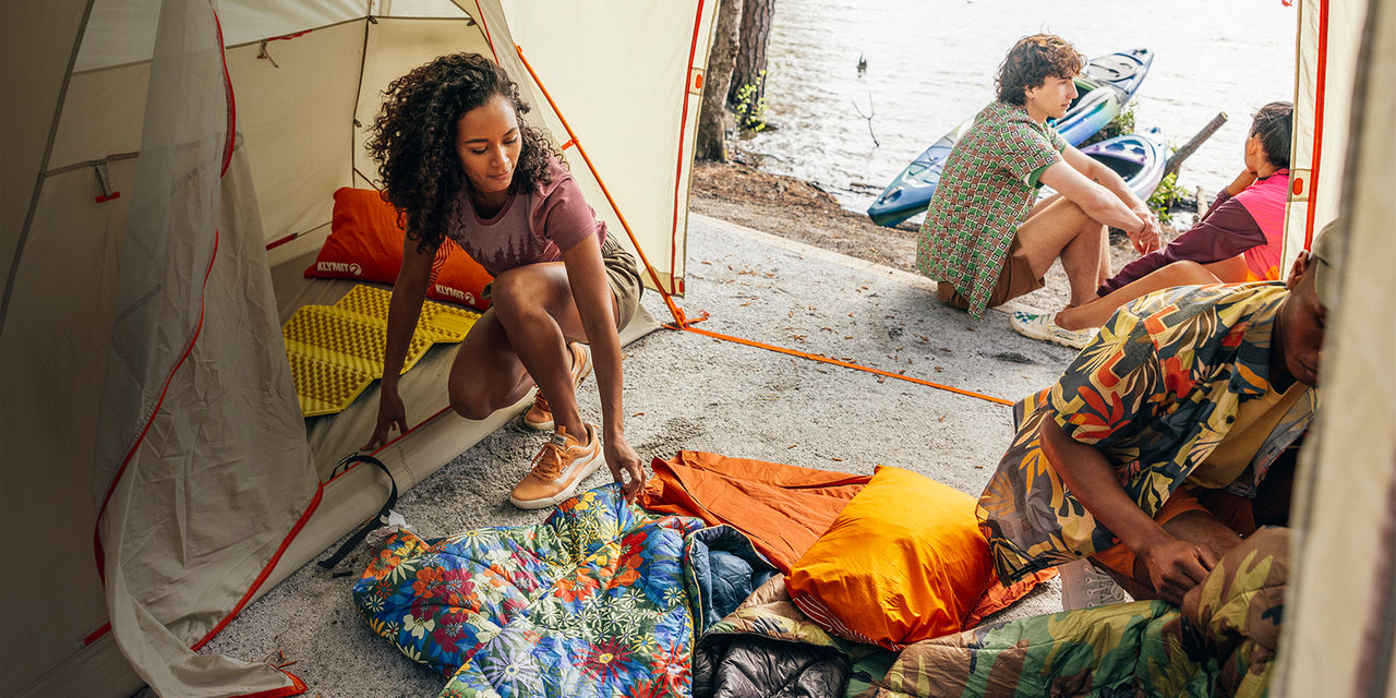 A group of friends set up camp on a beach