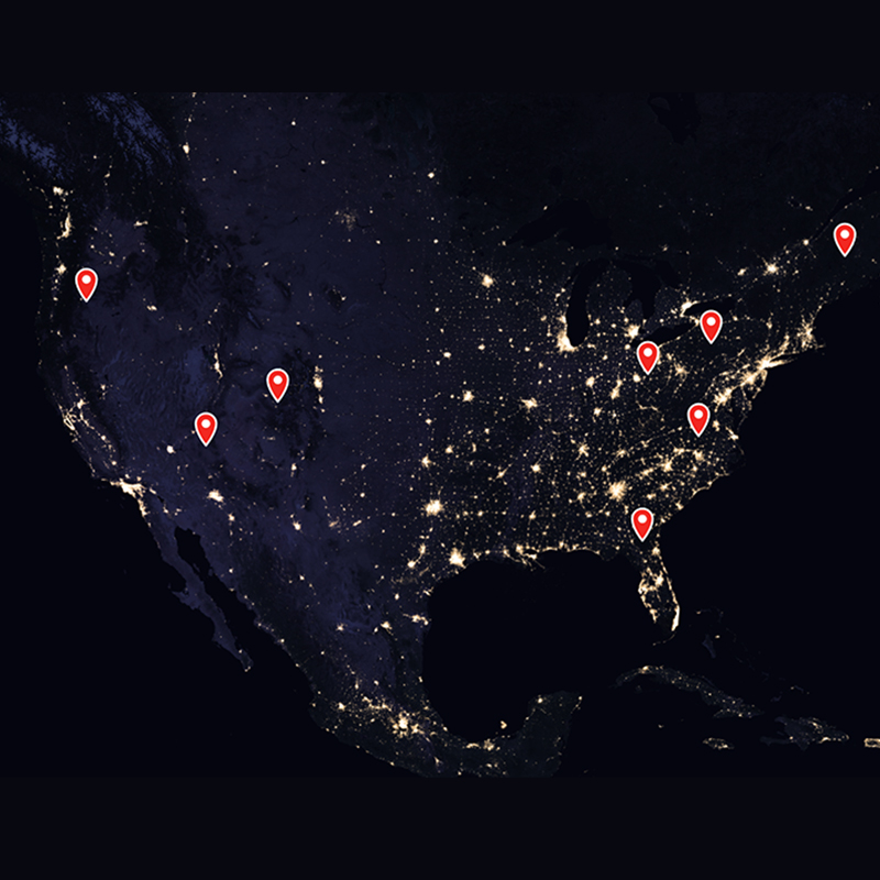 A view of the earth at night with pins for dark sky locations