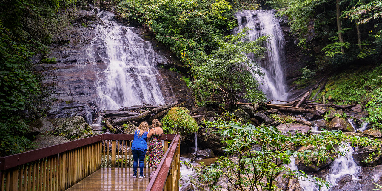 Two women look at Anna Ruby falls in Helen, Georgia
