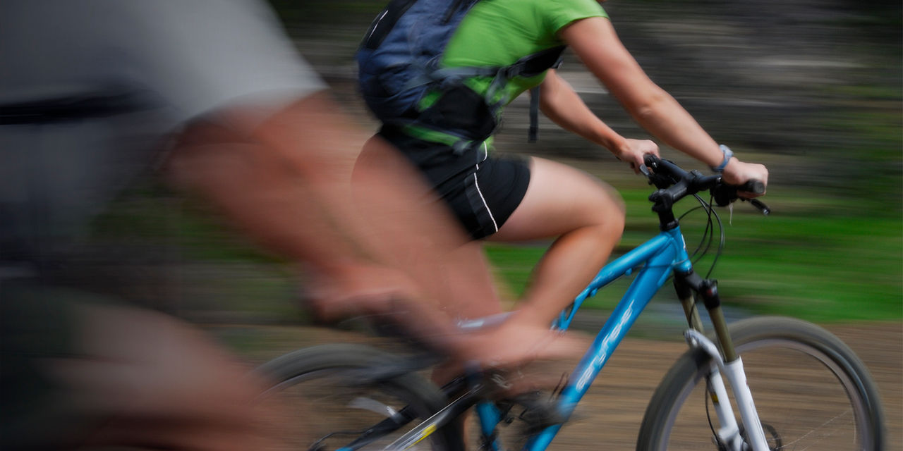 Two bikers blurred by speed
