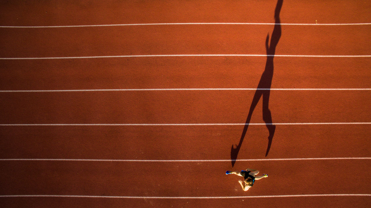 Shot of a young male athlete training on a track