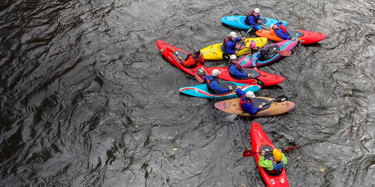 Group of kayakers guided by a professional guide 