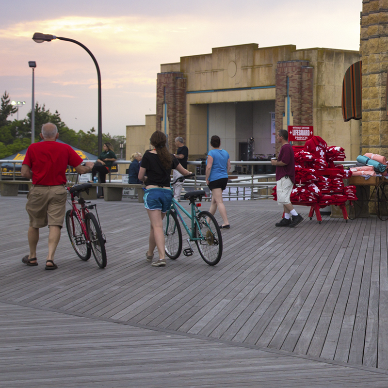 Bikers on the boardwalk and beach shop at historic Jones Beach State Park in Wantagh Ny