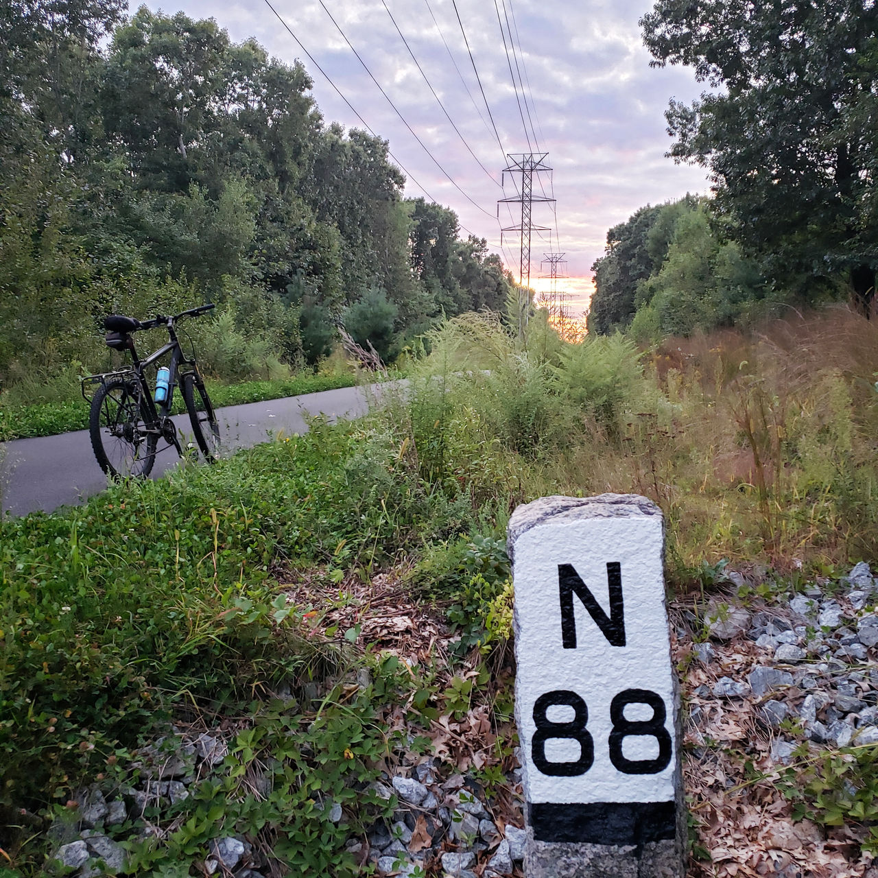 A bike is seen near wayland 88 miles to northampton 16 miles to boston