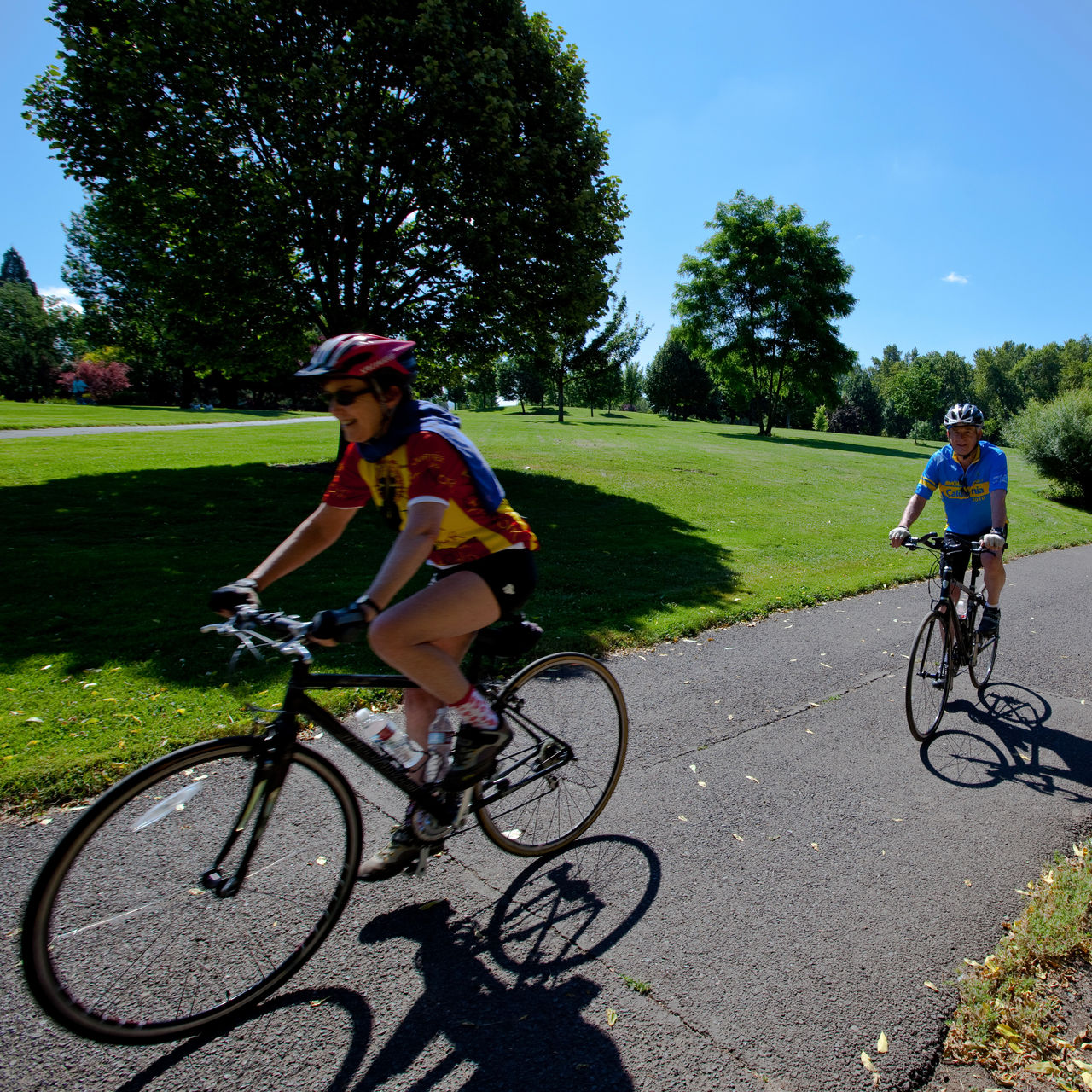 Two people bike the Bear Creek Greenway