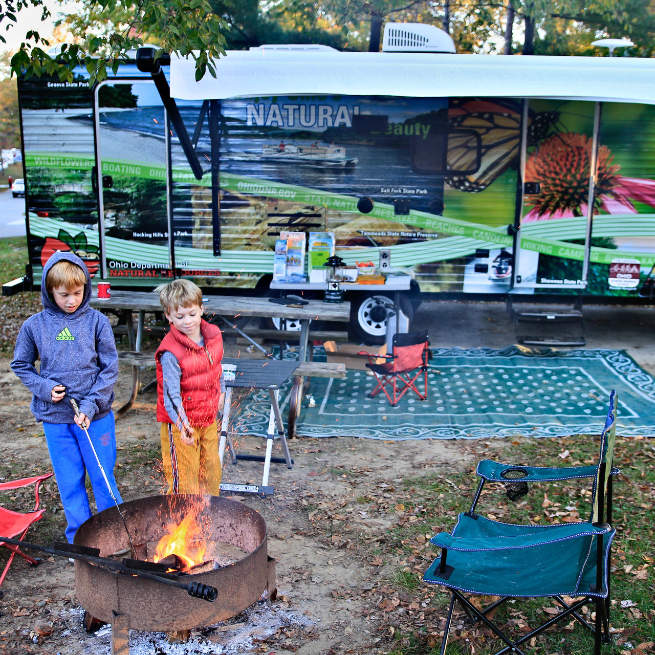 Two children by a campfire in Hocking Hills at the campground