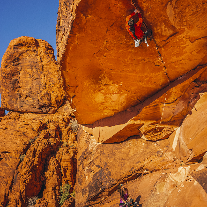 A photo of Chris Weidner on a climb being belayed by Heather Weidner