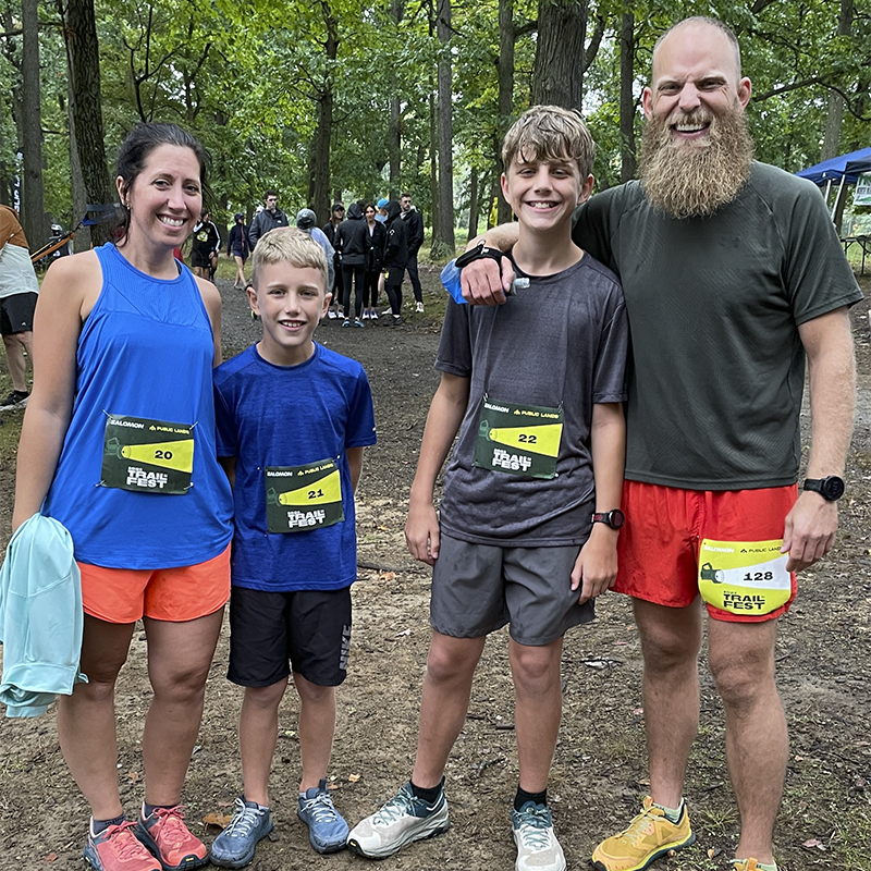 A family of runners poses for a photo at the Salomon x Public Lands Trail Fest 