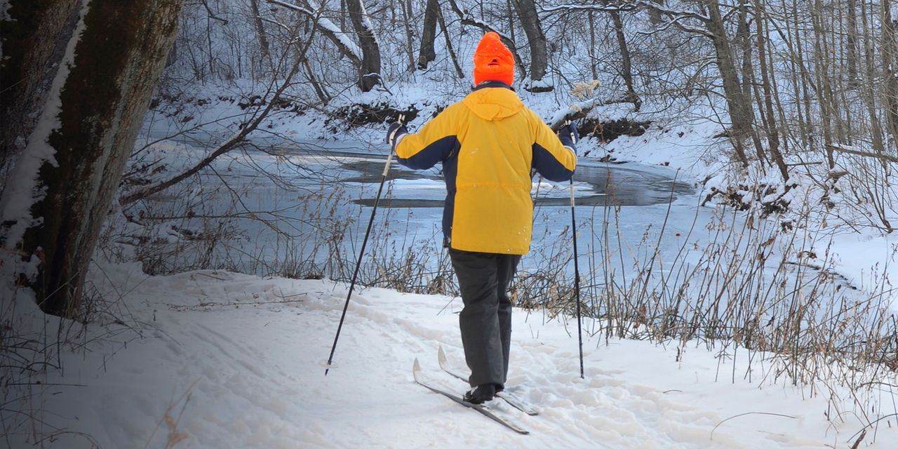 A cross country skiier skis in the snow