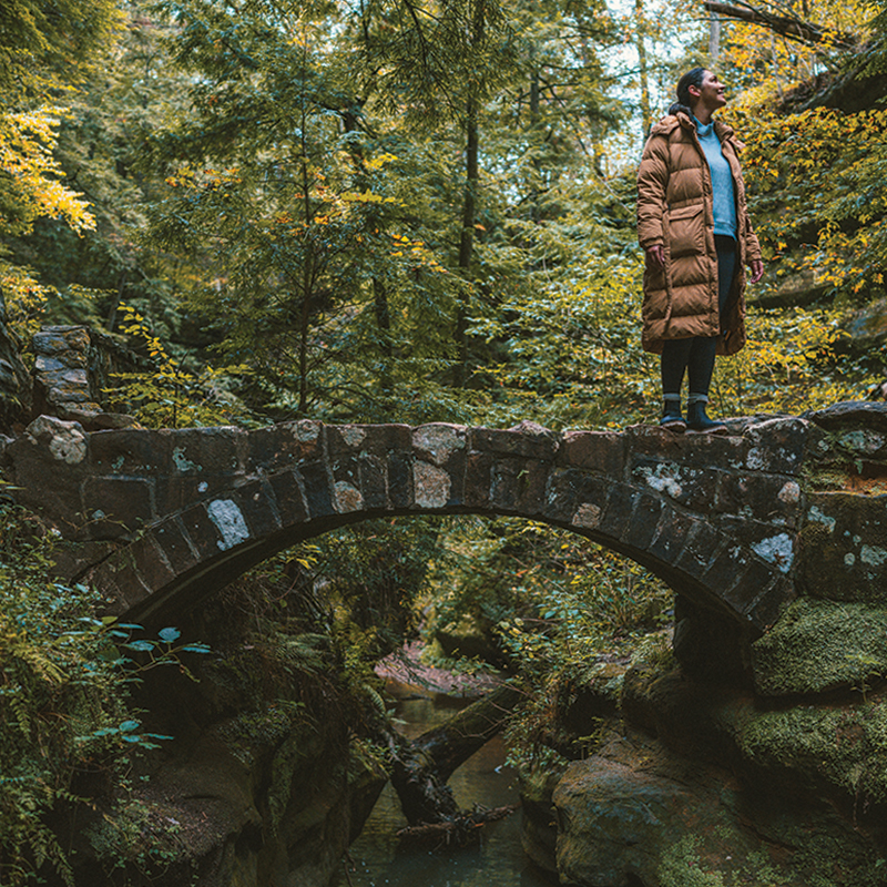 Woman standing on bridge in Hocking Hills