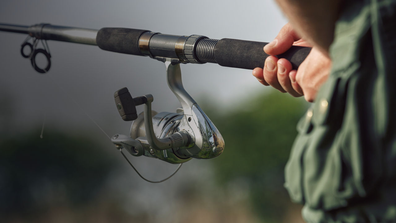 A spinning reel fishing on the lake