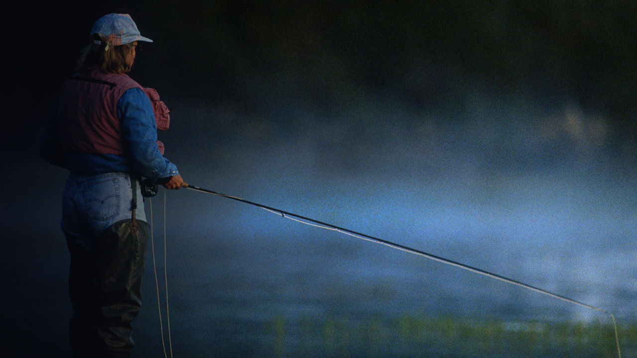 A woman fly fishing in a river