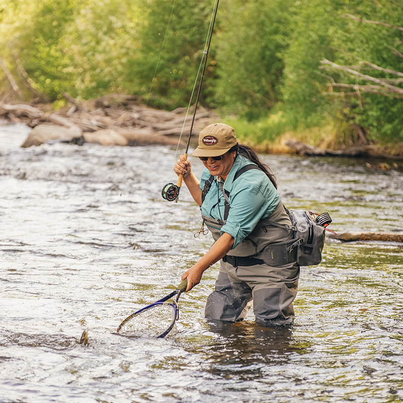 Erica Nelson fly fishing in the river