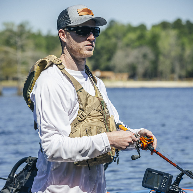 A man wears a vest while fishing