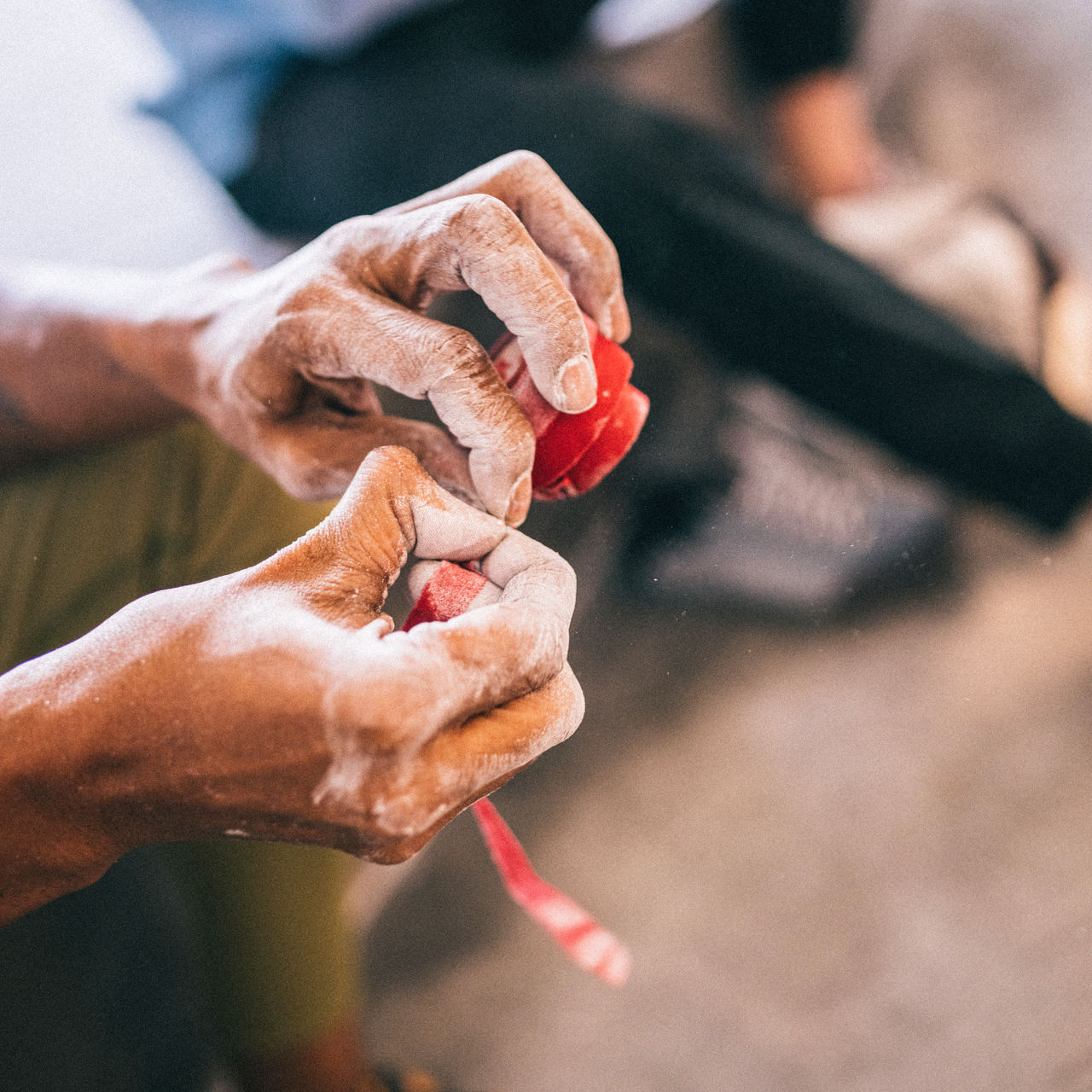 A detail of a climber applying climbers tape to hands