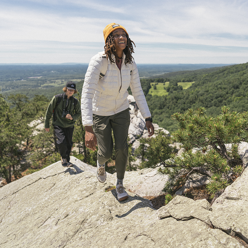 A woman smiles as she hikes