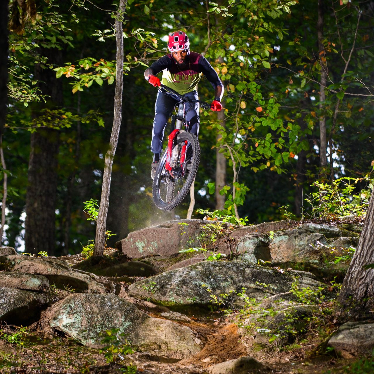 Angelo Wash rides his bike downhill