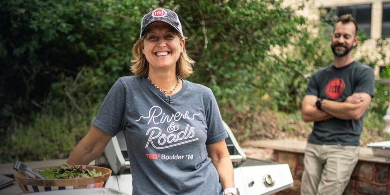 Kelly Bailey Newlon smiles next to food she has made