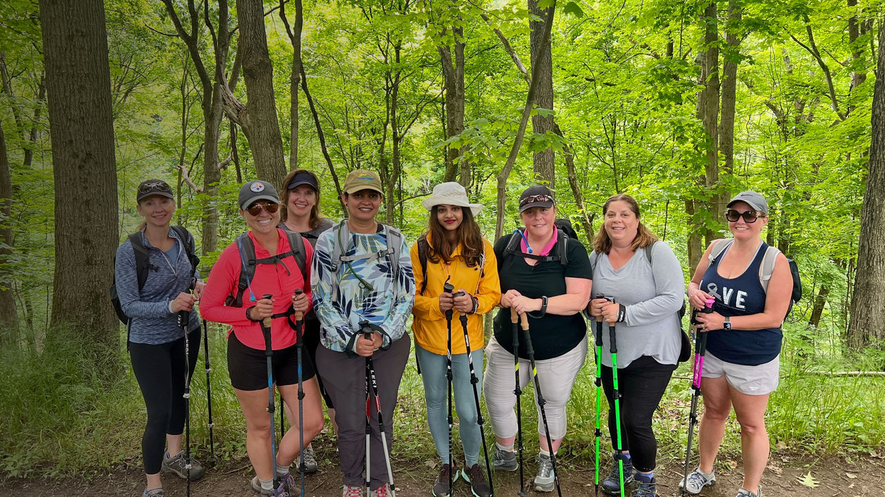 Women pose for a group photo while hiking