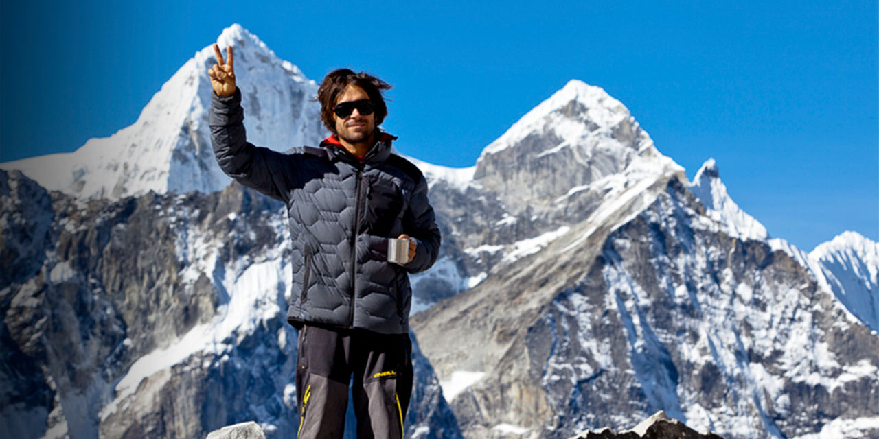 Jeremy Jones poses for the camera in front of a mountain
