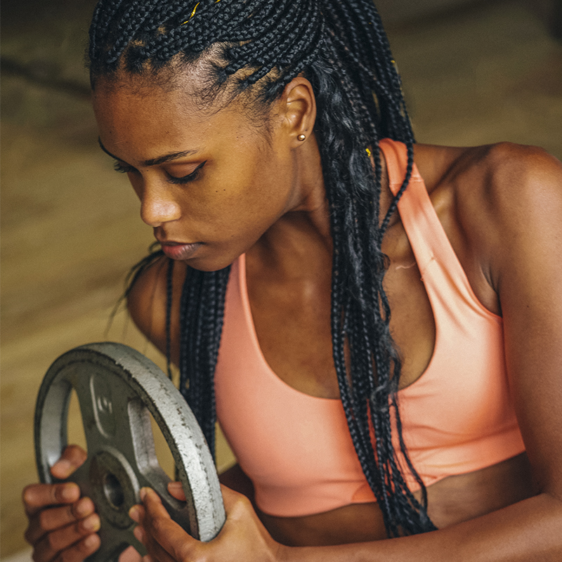 A woman does exercises with a weight