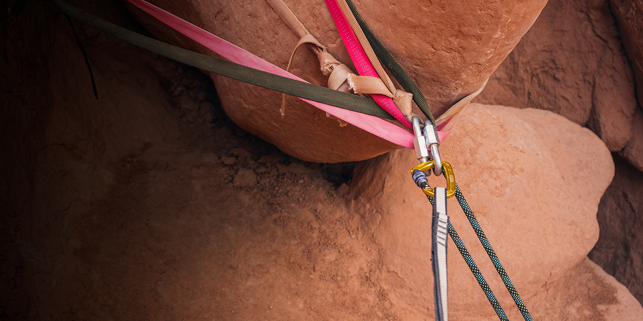 A rappelling anchor around a rock in southern Utah