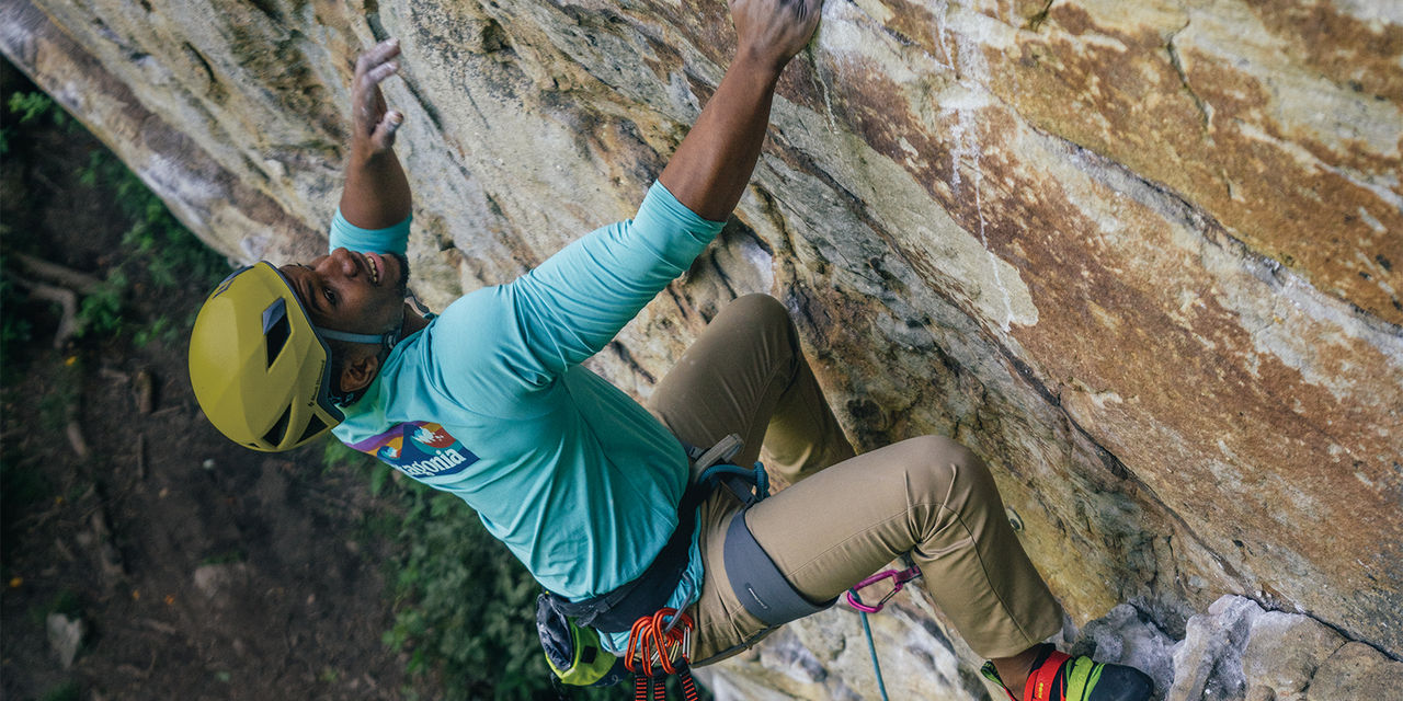 Climber on a rock wall wearing helmet