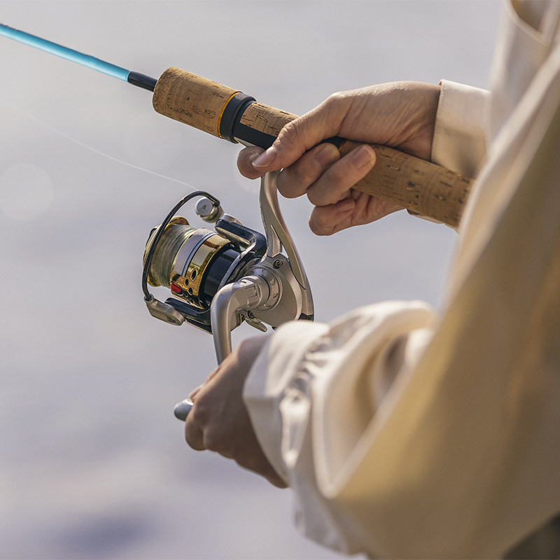 A woman holds a saltwater fishing reel