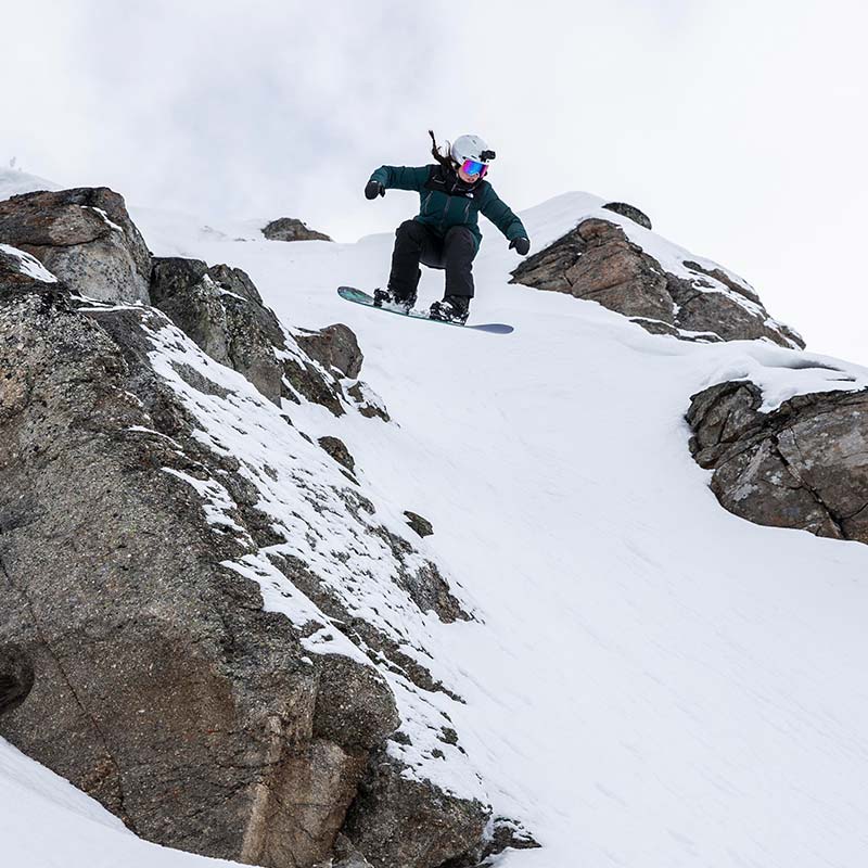 female snowboarder doing a jump