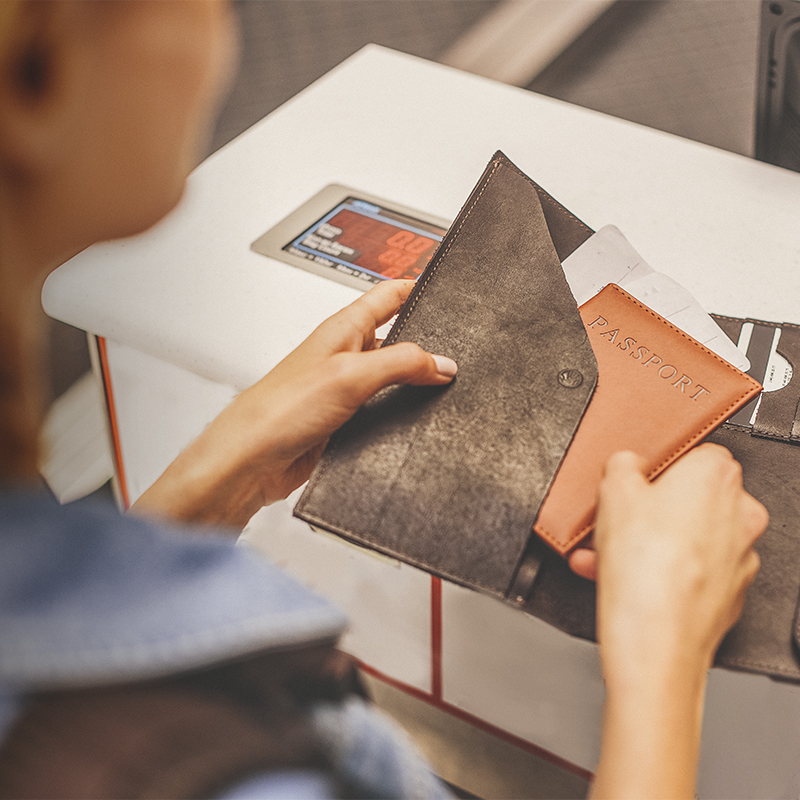 A woman takes her passport out of her wallet